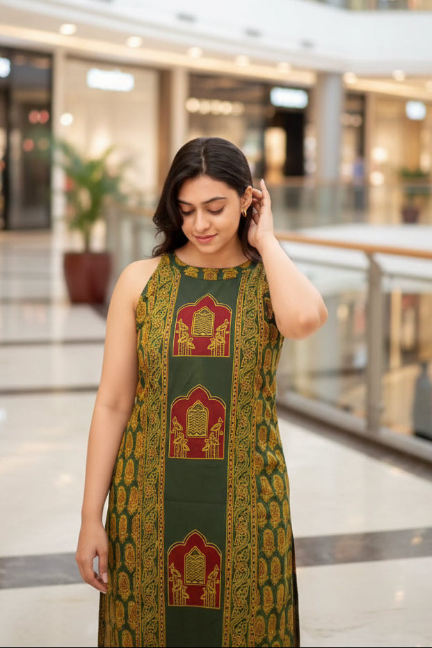 Woman wearing a green and gold traditional outfit with intricate patterns.