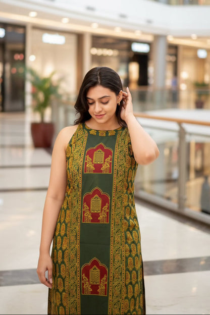 Woman wearing a green and gold traditional outfit with intricate patterns.