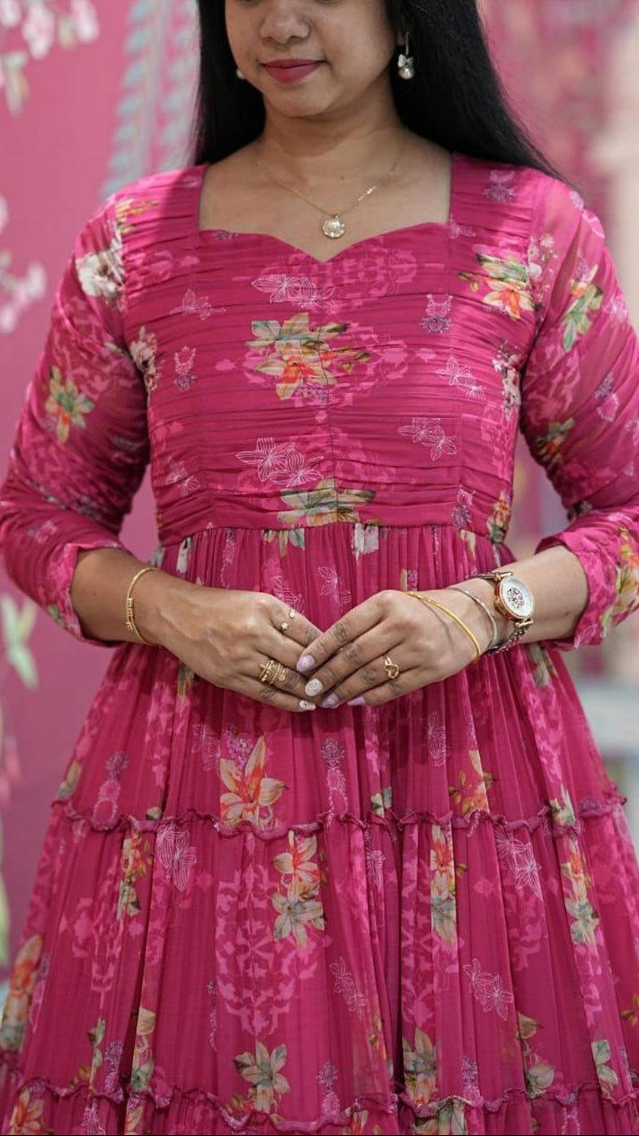 Woman wearing a pink floral dress against a pink floral background