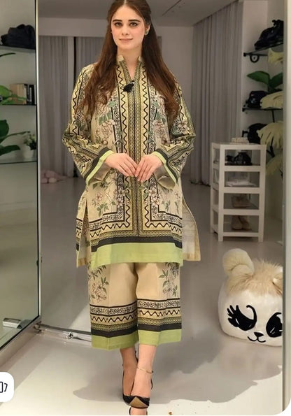 Woman wearing a patterned outfit in a room with shelves and decor.