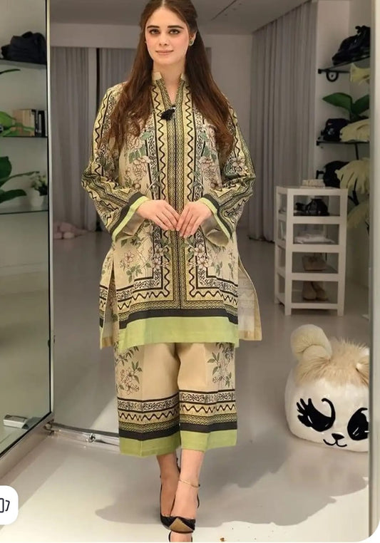 Woman wearing a patterned outfit in a room with shelves and decor.
